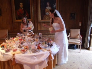 sweets table with sweets all around the 3-tier centrepiece
