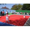 The opening match is a hard fought game, with spectators spilling onto the court.