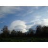 Strange saucer-like cloud formations to the left of the mountain