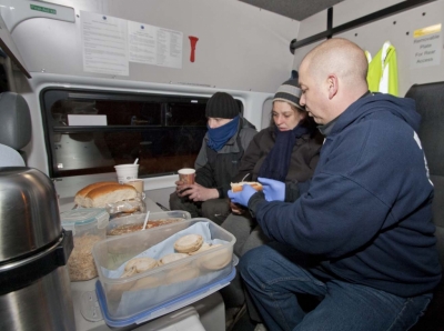 Chris Mounteney, Operations Manager of 'UK Homes 4 Heroes', prepares hot food, in a specially-equipped van, for 2 Northampton homeless.