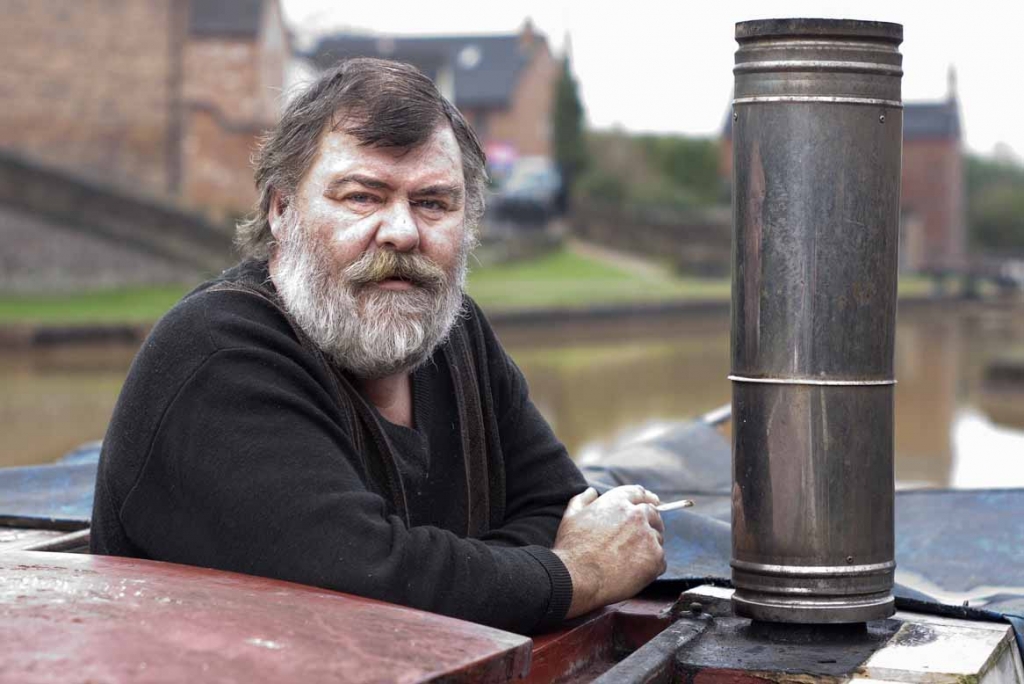A narrowboat owner, on the Trent and Mersey Canal at Kidsgrove, on 9th February 2013.