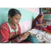 Girl and elderly woman doing needlework in village near Bhuj, Gujarat, India.