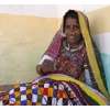 Woman in traditional outfit, doing needlework in village near Bhuj, Gujarat, India.