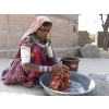 Woman in traditional outfit, doing washing in village near Bhuj, Gujarat, India.