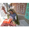 Woman in traditional outfit, doing needlework in village near Bhuj, Gujarat, India.