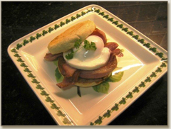 poached egg and grilled bacon in an english muffin