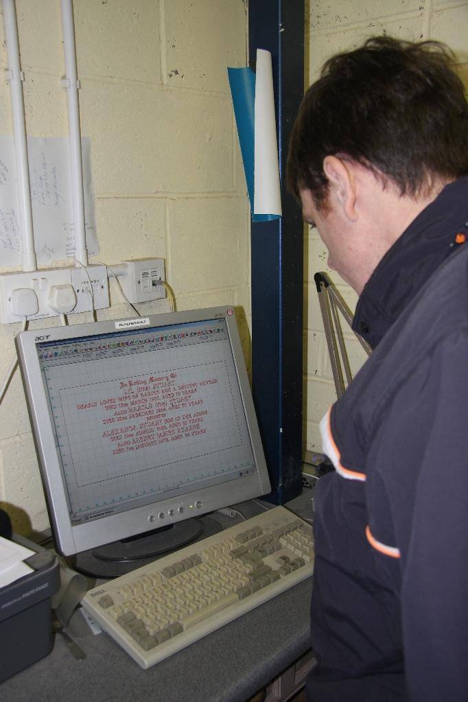 Stephen Gregg creating the layout and wording on a memorial headstone