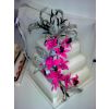 Three tier wedding cake with large spray og flowers