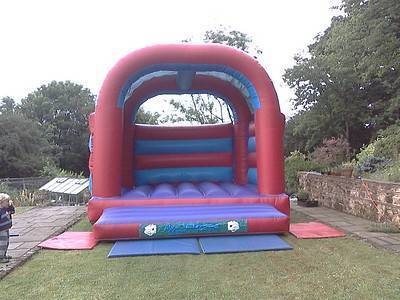 15 x 17 red and blue adult bouncy castle.