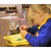 child decorating a bag