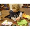 child decorating a bag