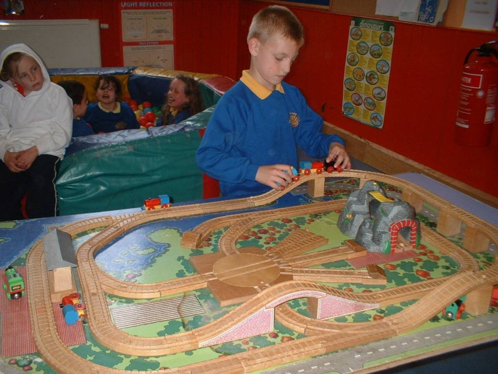 child playing with train track